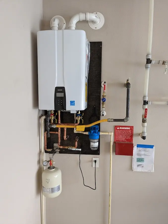 Professional plumber installing copper piping in a East Camden home